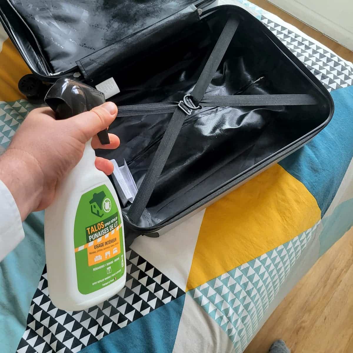Pulvérisation du spray répulsif Talos à l'intérieur d'une valise